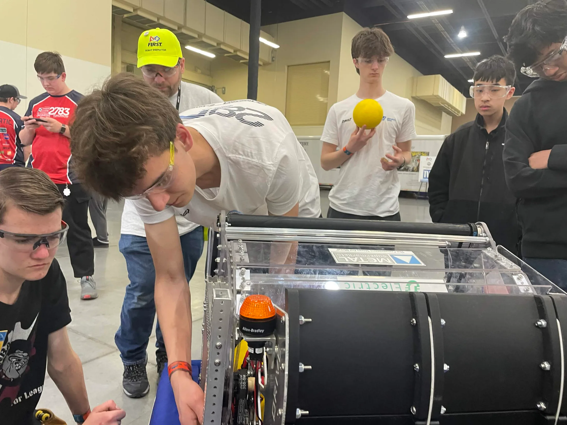 Planetary Drive students troubleshooting their robot at competition